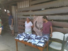 Uniforms ready to distribute. The school director Tony and his mom who prepares the meals